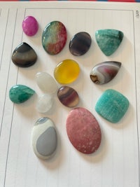 a variety of stones are laid out on top of a notebook