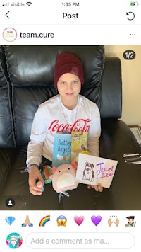 a boy with a hat holding a card