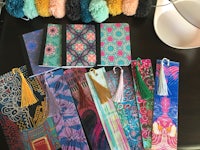 bookmarks with tassels and pom poms on a table