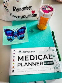 a medical planner on a table next to a butterfly